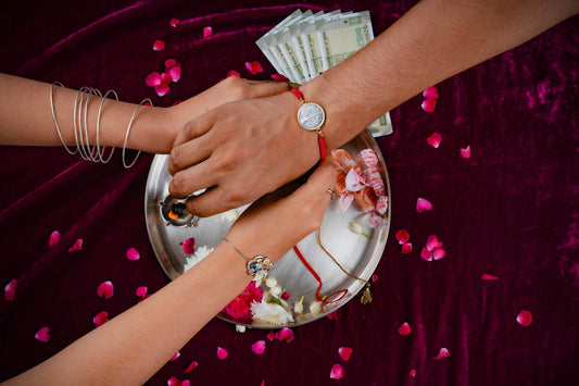 Sister Tying rakhi to brother